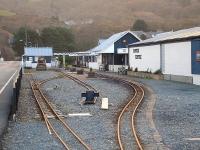 Track layout at the Fairbourne Railway main station site looking towards the buffer stops from alongside Beach Road. The Network Rail level crossing is just visible in the left background beyond the far building. [See image 31267] <br><br>[David Pesterfield 07/12/2011]