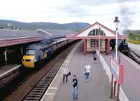 The up GNER <I>'Highland Chieftain'</I> HST calls at Aviemore in May 2002. On the right is Ivatt 2MT 4-6-0 no 46512 with a recent arrival from Boat of Garten standing at the Strathspey Railway platform.<br><br>[John Furnevel 11/05/2002]