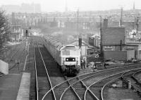 An April afternoon in 1980, standing on the footbridge at Slateford station in the Edinburgh suburbs. Locomotive 47703 <I>'St Mungo'</I> is rapidly approaching heading south west towards Carstairs with the 13.22 Edinburgh - Taunton.<br><br>[John Furnevel 13/04/1980]