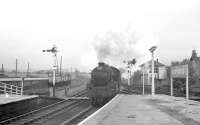 45498 brings a train from Glasgow into the Largs branch platform at Kilwinning in May 1963. Kilwinning Junction signal box stands in the right background.<br><br>[R Sillitto/A Renfrew Collection (Courtesy Bruce McCartney) 25/05/1963]