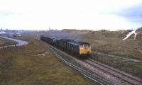 A class 24 with the daily freight from Fraserburgh skirts the dunes as it heads back towards Aberdeen in the summer of 1974.<br><br>[David Spaven //1974]