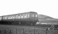 A passing DMU working 'wrong line' to Largs during reballasting work in Kilruskin cutting near West Kilbride on Easter Sunday 1963.<br><br>[R Sillitto/A Renfrew Collection (Courtesy Bruce McCartney) 14/04/1963]