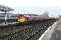 Red liveried DBS 66097 with HTA empties southbound for New Cumnock emerging from Kilmarnock Long Lyes on 2 February 2012.<br><br>[Ken Browne 02/02/2012]