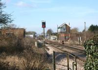 The signalbox at Minster looking west towards the station on 23 February 2012. The photograph is taken from the middle of a triangular junction with lines running past towards Dover (left) and Ramsgate (right). There had been a number of railway staff in hi-viz clothing in the area earlier, however, at this point in time they were behind the signalbox assisting with the removal of a trespassing goose!<br><br>[John McIntyre 23/02/2012]