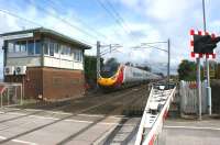 A northbound Pendolino has just passed Hest Bank level crossing frame box on 11 August 2009.<br><br>[John McIntyre 11/08/2009]