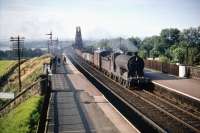 One of St Margarets shed's J37 0-6-0s no 64576 brings a freight off the Forth Bridge on a pleasant August afternoon in 1959 as it drifts south through Dalmeny station.<br><br>[A Snapper (Courtesy Bruce McCartney) 08/08/1959]