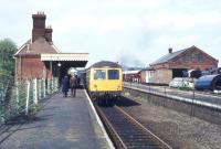 A DMU calls at Chappel and Wakes Colne on the Marks Tey - Sudbury branch in May 1979. This is also the location of the East Anglian Railway Museum, the main building of which stands on the right. <br><br>[Ian Dinmore 03/05/1979]