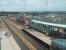 Looking towards Rotherham from the glass footbridge at Meadowhall as Sheffield Supertram 114 arrives at the interchange. The line of white poles denotes the tram route which turns sharp right just in front of the M1 Tinsley Viaduct to loop back towards the city centre.<br><br>[Mark Bartlett 19/03/2011]