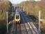 Immediately south of Standish station was Standish Junction, where the Whelley Loop left the WCML and ran to the east of Wigan. In this picture looking north towards the site of Standish station a Virgin Voyager heads north on 15 January 2012. The burrowing junction under the WCML can just be identified beyond the second OHLE stanchion on the right with the brick tunnel entrance almost at right angles to the track.<br><br>[John McIntyre 15/01/2012]