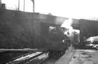 Snow in evidence at West Kilbride on 15 March 1963 as BR Standard class 4 no 80049 brings a Largs train under Law Brae and into the platform.  <br><br>[R Sillitto/A Renfrew Collection (Courtesy Bruce McCartney) 15/03/1963]