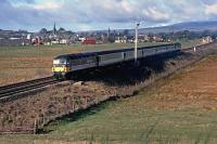 The 09.25 Glasgow Queen Street to Aberdeen ScotRail Express hauled by 47 703 speeds past Blackford village in April 1989, its DBSO at the rear. The following year, an hourly service of Class 158 DMUs replaced these push-pull sets. The DBSOs ended up paired with Class 86 locos on the (then) newly electrified London to Norwich service.<br><br>[Mark Dufton /04/1989]