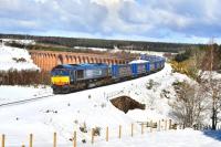 Nine days after the hottest March day in Scotland since records began [see image 38119] came heavy overnight snow with showers continuing through into the following day. DRS 66303 comes off Culloden Viaduct on 3 April 2012 heading south with the Tesco container train.<br><br>[John Gray 03/04/2012]