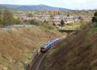 A First TransPennine Express Class 185 on a service to Manchester Airport enters Chorley as it leaves the deep cutting on the north side of the town on 31 March 2012. Beneath the photographer is Chorley Tunnel and in the background is Rivington Pike on the West Pennine Moors.<br><br>[John McIntyre 31/03/2012]