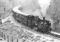 No. 9 <I>Prince of Wales</I>, on the 14.15 departure from Aberystwyth, having to cope with heavy snow as it struggles uphill about half a mile short of its destination at Devil's Bridge on 28 March 1975. The fireman can be dimly made out sanding from the front buffer beam in a scene more reminiscent of the Darjeeling Himalayan Railway.<br><br>[Bill Jamieson 28/03/1975]