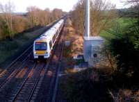 A down Chiltern Trains unit heads North from Banbury past the pleasant Oxfordshire village of Cropredy in March 2012. The village station closed in 1956, but the radio mast on the right gives an up-to-date touch.<br><br>[Ken Strachan 28/03/2012]