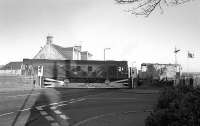 24129 crosses the A955 road at Dysart on 17 December 1975 with a brake van in tow. The train is heading back along the branch from Frances Colliery towards the exchange sidings and the main line.<br><br>[Bill Roberton 17/12/1975]