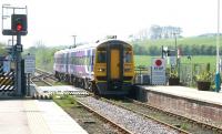 The 0941 Sheffield - Scarborough service arrives at Hunmanby over Bridlington Road level crossing on a bright and sunny 21 April 2009. <br><br>[John Furnevel 21/04/2009]