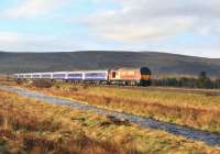 67016 with the Inverness portion of the Caledonian Sleeper north of Moy on the morning of 12 April. The Moy Burn runs past in the foreground.<br><br>[John Gray 12/04/2012]