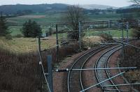 This view looks south at Lampits Junction, Carstairs, in 2004. This junction was the north east end of the curve from Float Junction, Carstairs. The triangular junction (Carstairs, Float, Lampits) opened in 1848 and the east side closed officially in 1860 being replaced by the more sharply curved Strawfrank to Dolphinton curve (opened 1872). The Dolphinton Branch cut through the disused trackbed.<br><br>[Ewan Crawford 22/12/2004]