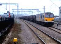 I have a soft spot for 92's. At the very least, they make a change from the ubiquitous 66's. 92030 <I>'Ashford'</I> is seen here passing through Rugby at about 7am on 9 March heading south with a mixed consist of tanks and flat wagons.<br><br>[Ken Strachan 09/03/2012]