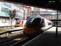 A recently introduced eleven coach Pendolino (390156) waits at Birmingham New Street with the 11.49 service to Wolverhampton on 17 April 2012. Across at platform 2 a sister set prepares to depart with a service for Euston.<br><br>[David Pesterfield 17/04/2012]