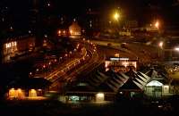 A tour train (the Royal Scotsman?) in Oban station at night in 1992. The train was rather too long for the platform and ran from the buffers round the bend up to where the signalbox had been located. This view is from McCaig's Folly.<br><br>[Ewan Crawford 15/11/1992]