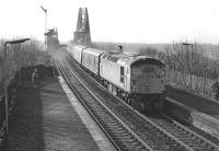 An unrecorded class 26 runs off the Forth Bridge and through North Queensferry station with a northbound class 1 working (possibly a Dundee train) at around 10.00 hrs on the morning of Saturday 25th March 1978. The spectators on the left seem totally unmoved by the event...<br><br>[Bill Jamieson 25/03/1978]