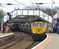 Just before the Duchess was due at Newton-on-Ayr with the <I>'Great Britain V'</I> on 26 April this Killoch - Drax coal train emerged behind 66585, snaking across from the Mauchline line and stopping to collect a crewman. It then crawled through the station blocking all views of the down line and potentially of  the Duchess - causing some anxiety among the waiting paparazzi.  Fortunately it had gone by the time the Pacific appeared. <br><br>[Colin Miller 26/04/2012]