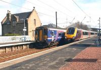 Long and short distance train services pass at Kirknewton on 17 April 2012.<br><br>[John Furnevel 17/04/2012]