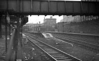 Looking back from the end of platform 6 (north) at Aberdeen during 'rationalisation' work in February 1973. View is across the truncated platform 7, with through platforms 8 and 9 beyond. Aberdeen North signal box is behind the camera. The building in the centre of the picture is the former suburban booking office and entrance to the covered cross-station walkway.<br><br>[John McIntyre /02/1973]