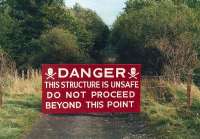 Warning sign on the approach to Byreburn Viaduct on the Langholm Branch in 1987. The wire presented no problems to the locals. Little trace now remains of the former structure. [See image 38778]<br><br>[Bruce McCartney //1987]