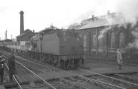Fowler 4F 0-6-0 no 44462 brings mineral wagons south through Hellifield in February 1965. The locomotive shed stands on the other side of the foot crossing.<br><br>[K A Gray 13/02/1965]