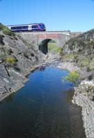 A northbound passenger train approaches Dalnacardoch from the south. In scorching heat that pool looked inviting.<br><br>[Ewan Crawford 25/05/2012]
