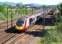 A northbound Pendolino hurries through Beattock on 27 May 2012 as a pair of DBS Class 66s are held in the loop waiting for a path north.<br><br>[John McIntyre 27/05/2012]