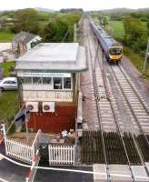 Looking North over the signal box at Hest Bank on what Winnie the Pooh would undoubtedly call a Blustery Day. A Transpennine 185 heads south towards the level crossing on 13 May 2012.<br><br>[Ken Strachan 13/05/2012]