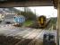 View under the station footbridge from the signal box walkway as 158835 approaches Ferryside station level crossing at speed on 14 March 2012. The train is the 10.30 ex-Manchester Piccadilly, with 80 minutes remaining of its 6 hour journey to Milford Haven.  <br><br>[David Pesterfield 14/03/2012]