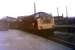 Class 40 No. 354 leads an evening van train standing in the parcels' siding at Accrington in 1970, shortly before this traffic ceased altogether. The train is in the old Bury line platform (closed 1966), but will have reversed into here and will go forward to continue its journey towards Colne. To the right of the loco old railway buildings stand in the middle of what had been a triangular junction - but not for much longer. Behind the train part of the huge Howard and Bullough factory complex can be seen. This company exported textile machinery all over the world and in 1953, to celebrate its centenary, hired 14 special trains to take the entire workforce from Accrington to Blackpool. By the time this picture was taken the factory was part of the Platt group but closed in the early 1980s and has since been demolished. In 2010 a brand new station building was built just about where the Class 40 is idling. [See image 32139].<br><br>[Mark Bartlett //1970]