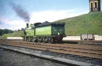 The north end of Dumfries on 13 June 1959 with ex-Great North of Scotland Railway 4-4-0 No 49 <I>Gordon Highlander</I> following arrival with the SLS <I>Golden Jubilee Special</I> from Buchanan Street. The building on the hill is the remains of the old 'lighthouse' signal box, now sadly demolished. [See image 3568]<br><br>[A Snapper (Courtesy Bruce McCartney) 13/06/1959]