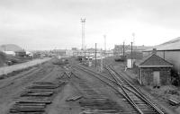 View west from Bathgate Central signalbox in December 1983, with tracklifting in progress. The former through station building is in the left background, beyond the new access road to what would become the car terminal.<br><br>[Bill Roberton 08/12/1983]