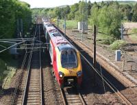 A southbound Virgin Voyager has just descended the 10 miles from Beattock Summit as it approaches Beattock village at speed on 27 May 2012. On the right the stub of the former Moffat branch can be seen.<br><br>[John McIntyre 27/05/2012]