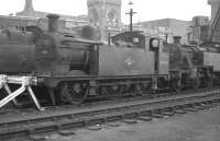 Ex-LMS locomotives stabled in the sidings at Kentish Town shed (14B) in October 1962. Class 3F 0-6-0T 47202 (of 1899 vintage) stands in front of 3P 2-6-2T no 40022. Both locomotives are fitted with condensing apparatus for operating over the Metropolitan widened lines.  <br><br>[K A Gray 28/10/1962]