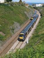 Two class 170 units pass between Kinghorn Tunnel and the station on 19 June. The cutting had been cleared of vegetation and stabilised earlier this year. In the background is the Art Deco former <I>Regal</I> cinema.<br><br>[Bill Roberton 19/06/2012]