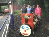 Less than a year after their adoption of Crookston Station, the 'Friends of Rosshall Park and Gardens' have recently taken delivery of a barrel train planter supplied by Glasgow City Council and planted with the help of their apprentices. Some of the 'Friends' are seen standing alongside the new addition on 21 June 2012. [See image 35831]<br><br>[John Yellowlees 21/06/2012]