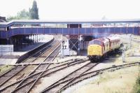 View west over March station on a sunny summer's day in July 1996, showing EWS 37057 hauling an EWS saloon about to come off the disused joint line.<br><br>[Ian Dinmore /07/1996]