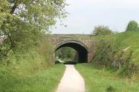 Like the other old stations on the <I>Tissington Trail</I> Alsop-en-le-Dale has been swept away since closure in 1954 and is only a car park and trail access point. Immediately north of the station site however is this fine bridge, still carrying the A515 Buxton to Ashbourne road over the old line, which has now been a cycle path for over forty years. View north towards Parsley Hay and Buxton. <br><br>[Mark Bartlett 24/05/2012]