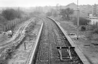 Looking east over Corkerhill station in February 1990, with new platform under construction on the left and the electrified headshunt from Corkerhill depot on the right. The station reopened in July that year. The housing development stands on the site of the original 'Corkerhill railway village' [see image 19972].<br><br>[Bill Roberton 24/02/1990]