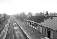 View west over Crookston station from Crookston Road bridge on 24 February 1990 showing the fire-damaged station building. [See image 15060]<br><br>[Bill Roberton 24/02/1990]