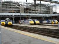 A symmetrical line up of HSTs and class 91s beneath ongoing glazing works on the north end screens at Kings Cross on 13 June 2012.<br><br>[David Pesterfield 13/06/2012]