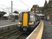 380104 waits at a gloomy Ayr station on 18 July with the 12.13 to Glasgow Central.<br><br>[Bill Roberton 18/07/2012]