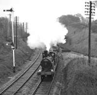 On May 1st 1976, <I>Hardwicke</I> and <I>Flying Scotsman</I> spent much of the day on display at Settle before working a second S&C centenary special. This one had originated at Blackburn and enjoyed steam power on the Hellifield to Carnforth leg of its return journey from Carlisle, seen here passing Wennington. As can be seen from the glistening rails, the weather was far from ideal for such an occasion. [See image 38631]<br><br>[Bill Jamieson 01/05/1976]